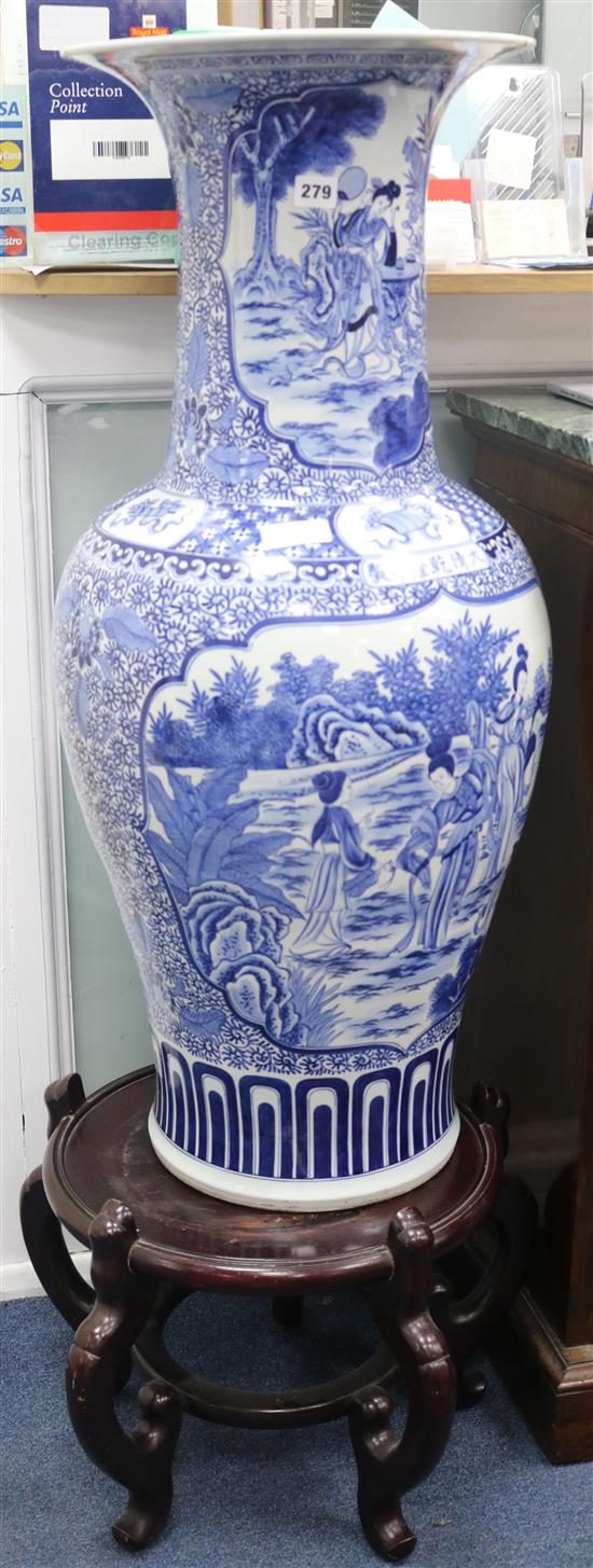 A massive Chinese blue and white vase and wood stand
